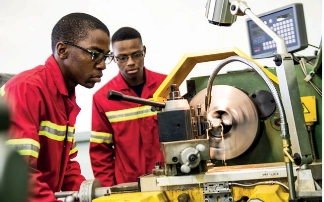 Engineer fabricating machine parts.