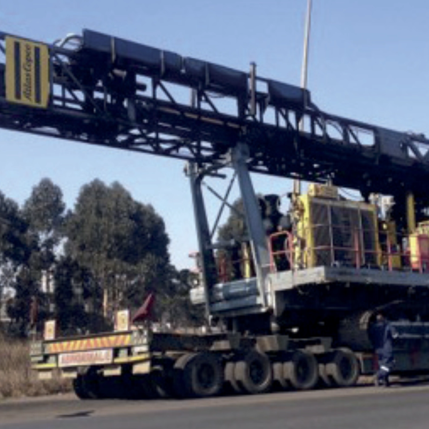 Excavator unloading into big truck.